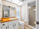 Bathroom features floral wallpaper, a shower stall, a window, and a vanity at 1211 Stony Brook Ln, Dunedin, FL 34698