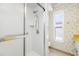 Shower with glass door, tiled walls, and window at 1211 Stony Brook Ln, Dunedin, FL 34698