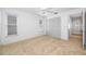 The carpeted bedroom provides ample lighting, windows, and closet space at 1211 Stony Brook Ln, Dunedin, FL 34698