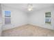 Bright bedroom with two windows and neutral carpeting at 1211 Stony Brook Ln, Dunedin, FL 34698