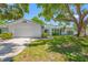 Charming single-story home with a well-maintained lawn and mature trees offering shade at 1211 Stony Brook Ln, Dunedin, FL 34698