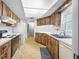 Well-lit kitchen with ample counter space, appliances, and tile flooring at 1211 Stony Brook Ln, Dunedin, FL 34698