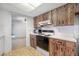 Well-lit kitchen featuring tile floors, ample counter space, and a view into the living room at 1211 Stony Brook Ln, Dunedin, FL 34698
