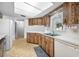 Functional kitchen featuring tile floors, ample counter space, and modern appliances at 1211 Stony Brook Ln, Dunedin, FL 34698