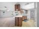 Cozy kitchen featuring wood cabinets, white countertops, and a breakfast bar overlooking the living area and pool at 1211 Stony Brook Ln, Dunedin, FL 34698