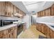 Spacious kitchen featuring tile floors, ample counter space, and modern appliances at 1211 Stony Brook Ln, Dunedin, FL 34698