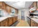 Traditional kitchen featuring wood cabinets, white countertops, and an open view to the adjacent room at 1211 Stony Brook Ln, Dunedin, FL 34698