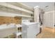 Laundry room with washer, sink, and shelving at 1211 Stony Brook Ln, Dunedin, FL 34698