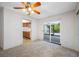 View of a living room leading to a kitchen and sliding glass doors to a pool area at 1211 Stony Brook Ln, Dunedin, FL 34698