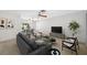 Cozy living room with modern furniture and plenty of natural light from sliding doors to the patio at 1211 Stony Brook Ln, Dunedin, FL 34698