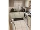 Efficient kitchen featuring white appliances and cabinetry for functional cooking space at 1220 57Th N St # 103C, St Petersburg, FL 33710