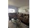 Cozy living room with recliner sofas, stylish decor, neutral rug, and bright natural light at 1220 57Th N St # 103C, St Petersburg, FL 33710