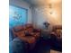 Cozy living room showcases reclining seating, and modern lighting for relaxing ambiance at 1220 57Th N St # 103C, St Petersburg, FL 33710