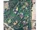Aerial view of a property surrounded by lush greenery and neighboring houses, showing its spacious land and location at 12433 Kelso Rd, Thonotosassa, FL 33592