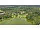 Breathtaking aerial perspective of the property featuring lake access and lush landscape at 12433 Kelso Rd, Thonotosassa, FL 33592
