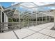 Enclosed porch with a grey floor and screened views of the sky and backyard trees at 12433 Kelso Rd, Thonotosassa, FL 33592