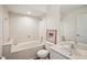 Neutral bathroom featuring a tub, sink, toilet, and white marble walls at 12433 Kelso Rd, Thonotosassa, FL 33592