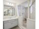 Neutral bathroom featuring a white vanity, shower and a decorative framed mirror at 12433 Kelso Rd, Thonotosassa, FL 33592