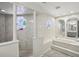 Luxurious bathroom featuring a tub, tiled shower, and accent stained glass windows at 12433 Kelso Rd, Thonotosassa, FL 33592