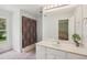 Clean and bright bathroom featuring a vanity with marble countertop, shower, and a window at 12433 Kelso Rd, Thonotosassa, FL 33592