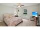 Cozy bedroom with a queen-size bed, neutral colors, and a window view of the outdoors at 12433 Kelso Rd, Thonotosassa, FL 33592