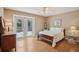 Bright bedroom featuring a ceiling fan and French doors leading to an outdoor space at 12433 Kelso Rd, Thonotosassa, FL 33592