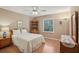 Well-lit bedroom featuring a ceiling fan, a window with blinds, and wooden floors at 12433 Kelso Rd, Thonotosassa, FL 33592