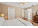 Well-lit bedroom featuring a ceiling fan, double closet, and an ensuite bathroom at 12433 Kelso Rd, Thonotosassa, FL 33592