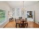 Charming dining room featuring parquet floors, a chandelier, and elegant wall decor at 12433 Kelso Rd, Thonotosassa, FL 33592