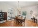 Bright dining room with hardwood floors, chandelier, and view of the front entry at 12433 Kelso Rd, Thonotosassa, FL 33592