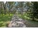 A long driveway leads to this home that is nestled among mature trees and landscaping at 12433 Kelso Rd, Thonotosassa, FL 33592