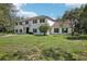 Stunning two-story home with manicured front lawn and classic architectural details at 12433 Kelso Rd, Thonotosassa, FL 33592