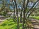 Exterior view of two-story home with lush lawn and mature trees at 12433 Kelso Rd, Thonotosassa, FL 33592