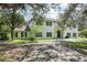 Spacious two-story home with traditional architectural details, black shutters, and balcony at 12433 Kelso Rd, Thonotosassa, FL 33592