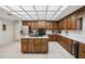 The kitchen has stainless steel appliances, a center island, and an abundance of wood cabinetry at 12433 Kelso Rd, Thonotosassa, FL 33592