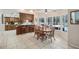 Eat-in kitchen featuring a breakfast bar, dining table, and a view of the pool at 12433 Kelso Rd, Thonotosassa, FL 33592