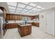 The kitchen features a unique ceiling, ample counter space, and an island with a cooktop at 12433 Kelso Rd, Thonotosassa, FL 33592
