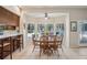 Bright eat-in kitchen with bar seating and a large window overlooking the outdoor pool at 12433 Kelso Rd, Thonotosassa, FL 33592