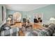 Inviting living room with hardwood floors, soft blue walls, and comfortable couches at 12433 Kelso Rd, Thonotosassa, FL 33592