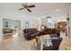 Open concept living room with tile floors, ceiling fans, and comfortable seating at 12433 Kelso Rd, Thonotosassa, FL 33592