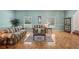 Traditional living room with parquet wood floors, couches, decor, and large windows at 12433 Kelso Rd, Thonotosassa, FL 33592