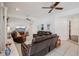 Cozy living room with tile flooring, ceiling fans, and comfortable leather furniture at 12433 Kelso Rd, Thonotosassa, FL 33592