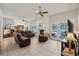 Bright living room featuring tile floors, a fireplace, and a view of the pool at 12433 Kelso Rd, Thonotosassa, FL 33592