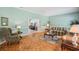 Bright living room with parquet wood floors, light blue walls, and doorway to other rooms at 12433 Kelso Rd, Thonotosassa, FL 33592