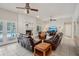 Spacious living room with tile flooring, fireplace, and comfortable leather furniture at 12433 Kelso Rd, Thonotosassa, FL 33592