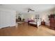Spacious main bedroom with hardwood floors, ceiling fan, and ample closet space at 12433 Kelso Rd, Thonotosassa, FL 33592