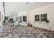 Large patio area with hexagon tile, ceiling fans, and bar for outdoor entertaining at 12433 Kelso Rd, Thonotosassa, FL 33592