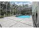 Beautiful in-ground pool and spa in screened enclosure with tile surround and elegant pillars at 12433 Kelso Rd, Thonotosassa, FL 33592