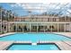 Beautiful in-ground pool and spa in screened enclosure with tile surround and second-story deck at 12433 Kelso Rd, Thonotosassa, FL 33592