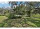 A glimpse of the private tennis court, surrounded by lush greenery and providing a secluded space for recreation at 12433 Kelso Rd, Thonotosassa, FL 33592